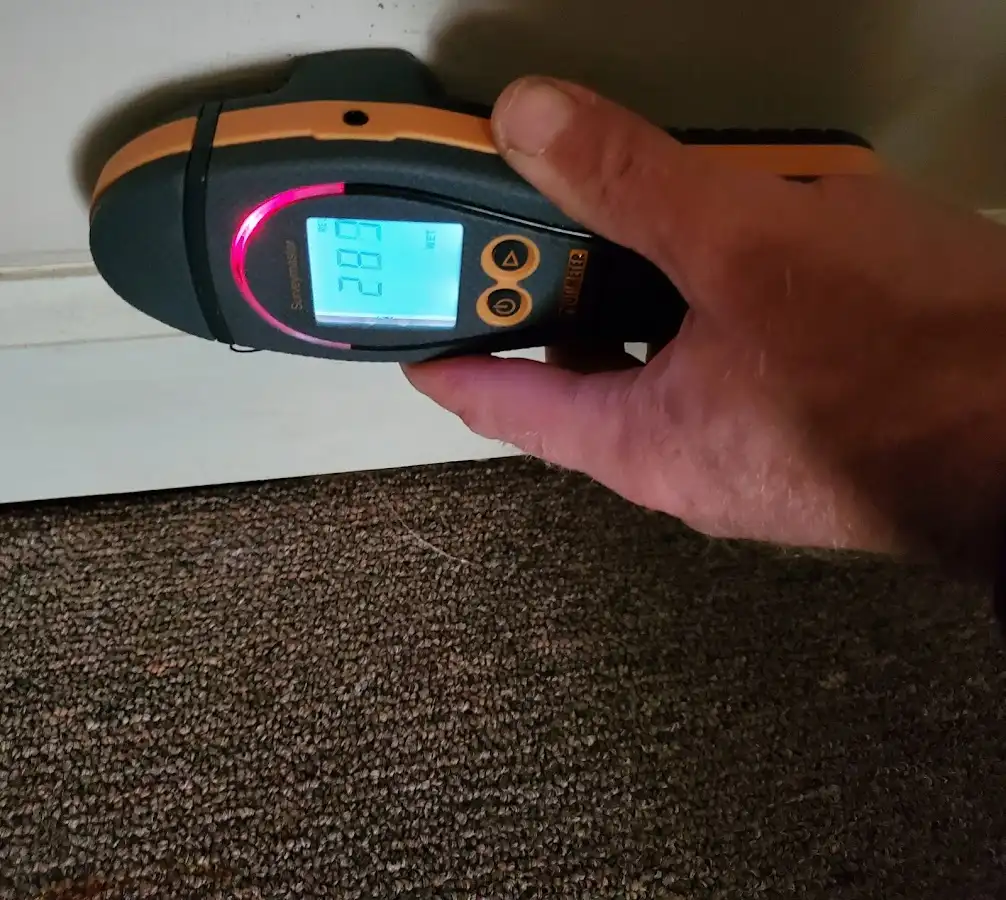 Moisture detection at baseboard during Storm Damage Restoration in Huntsville
